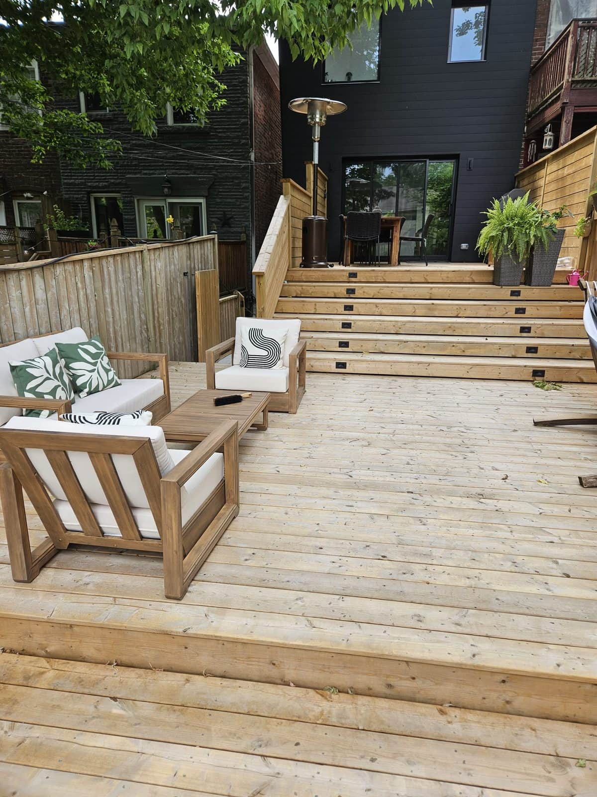 Clean deck boards under outdoor sofa and armchairs