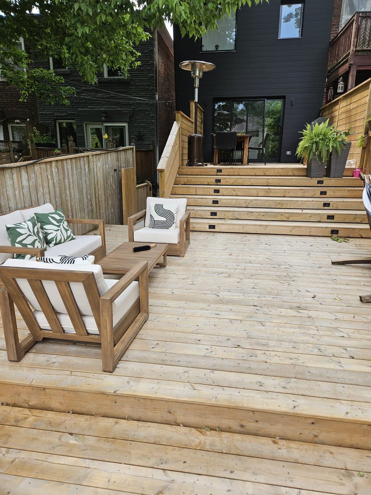 Clean deck boards under outdoor sofa and armchairs